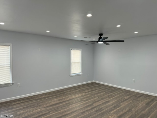 spare room featuring ceiling fan and dark hardwood / wood-style flooring