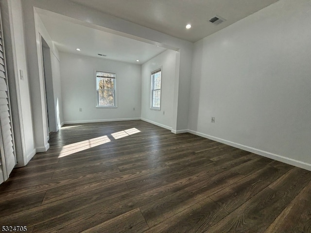 spare room with dark hardwood / wood-style floors