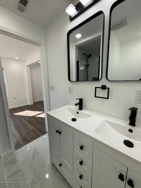 111 E Del A Vue Ave, Carneys Point Twp, NJ 08069 - bathroom featuring marble finish flooring, double vanity, and baseboards