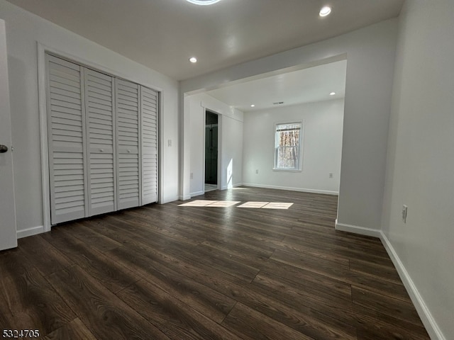 unfurnished bedroom with dark hardwood / wood-style flooring