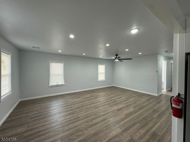 spare room with ceiling fan and dark wood-type flooring