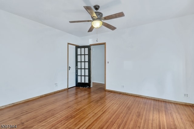 unfurnished room with ceiling fan and hardwood / wood-style flooring