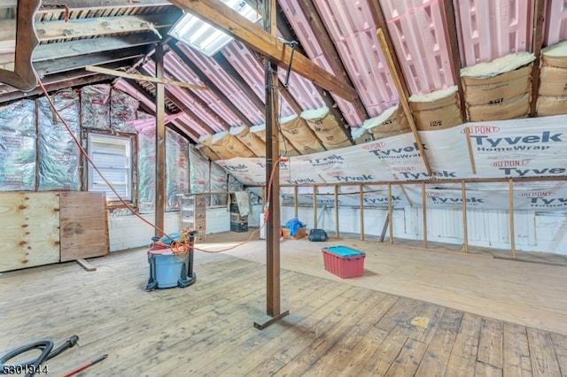 miscellaneous room featuring hardwood / wood-style floors and vaulted ceiling