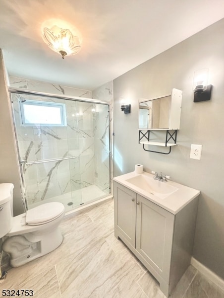 bathroom with vanity, toilet, and a shower with door