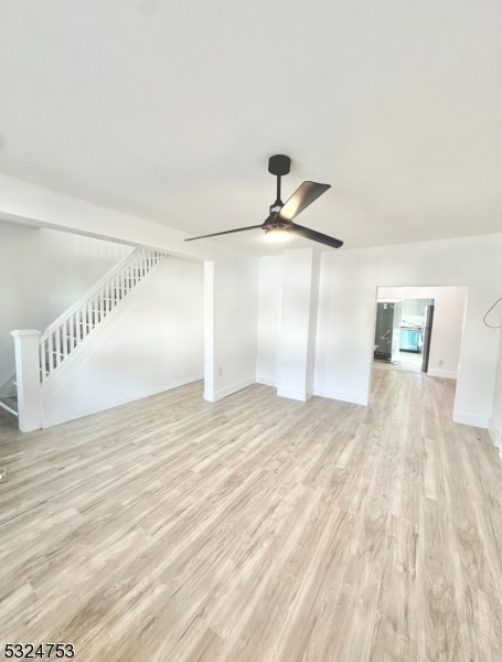 unfurnished living room with light hardwood / wood-style floors and ceiling fan