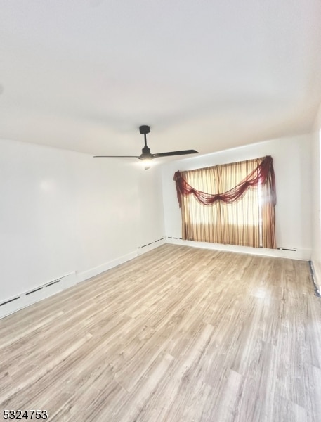 empty room featuring ceiling fan and light wood-type flooring