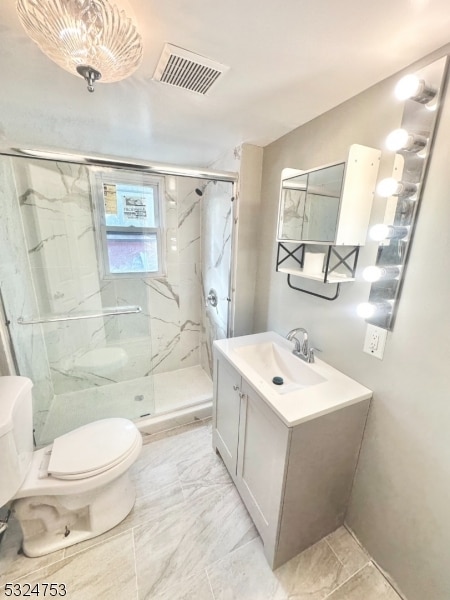 bathroom featuring vanity, toilet, and an enclosed shower