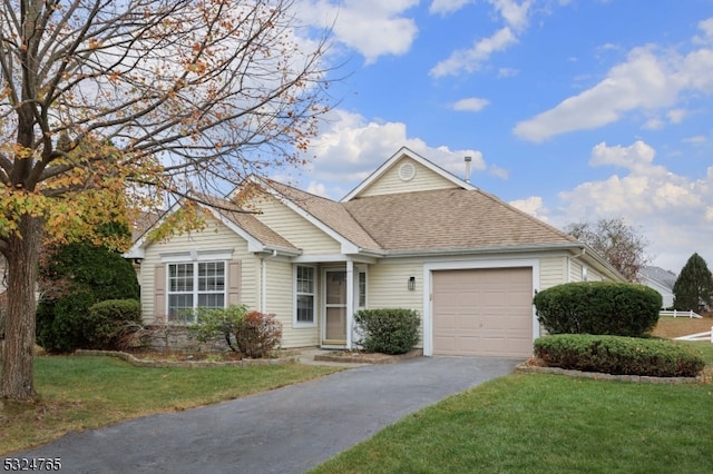 view of front facade featuring a garage and a front lawn