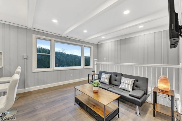 living room with beamed ceiling and hardwood / wood-style floors