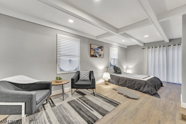 bedroom featuring beam ceiling and light wood-type flooring