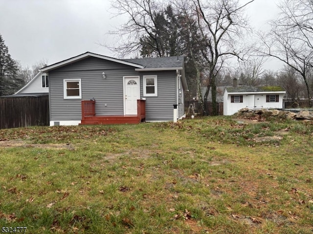 rear view of house featuring a lawn