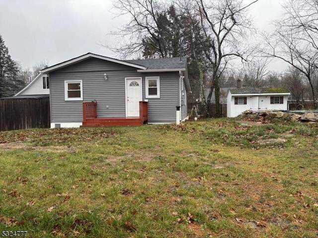 back of property featuring a lawn