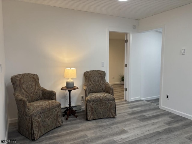 living area featuring hardwood / wood-style flooring and a baseboard radiator