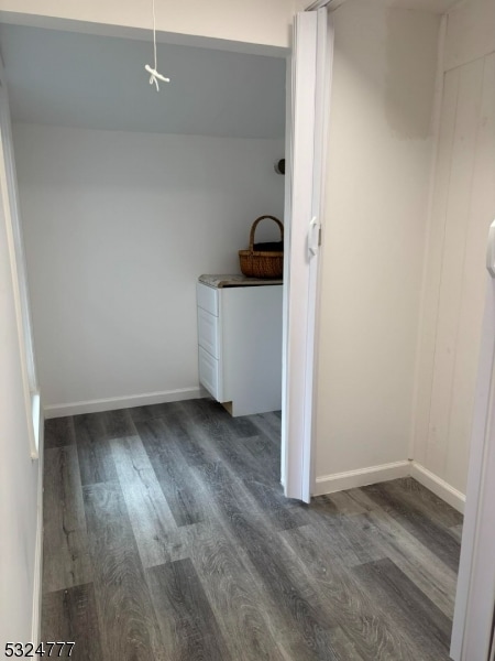 laundry room featuring dark wood-type flooring