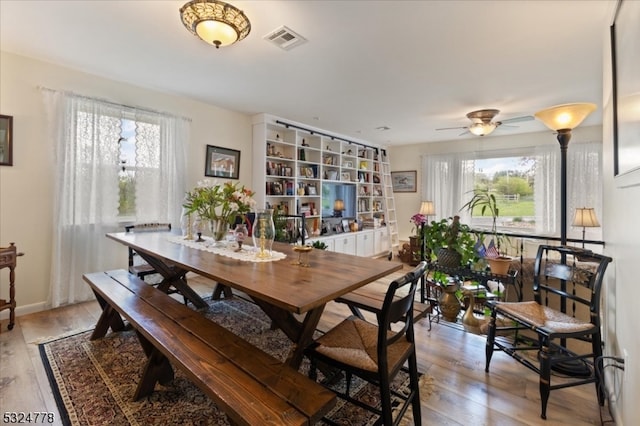 dining space featuring plenty of natural light, ceiling fan, and light hardwood / wood-style flooring