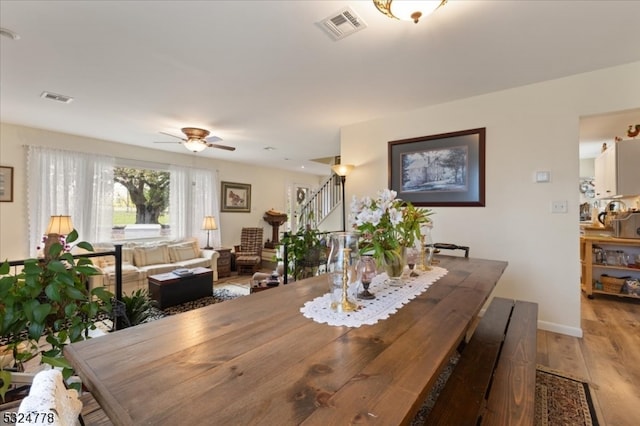 dining room with hardwood / wood-style flooring and ceiling fan