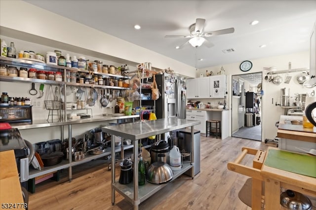 kitchen featuring stove, ceiling fan, light wood-type flooring, white cabinetry, and stainless steel fridge with ice dispenser