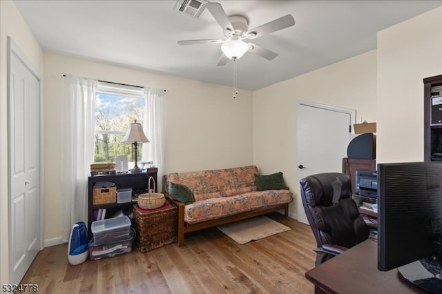 home office featuring hardwood / wood-style floors and ceiling fan