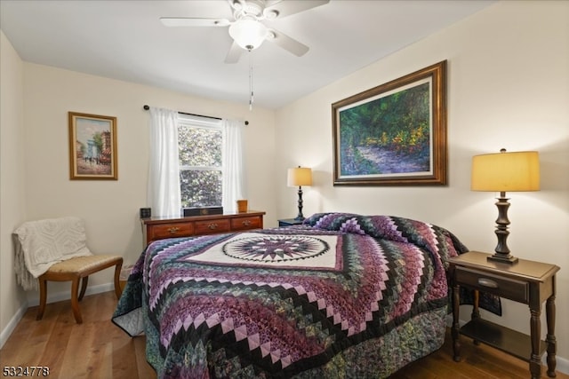 bedroom with ceiling fan and hardwood / wood-style flooring