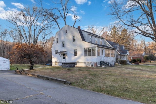 view of side of home with a lawn