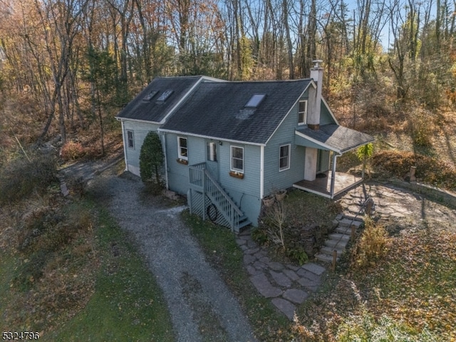 view of side of property featuring covered porch