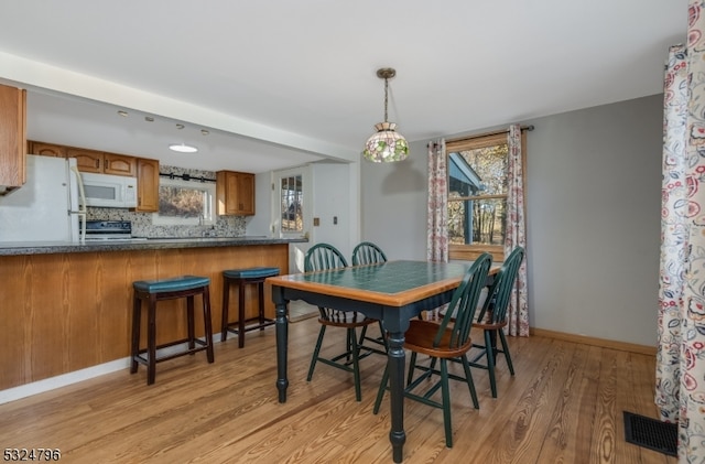 dining area with light hardwood / wood-style flooring