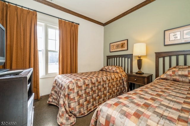 bedroom with crown molding and dark carpet