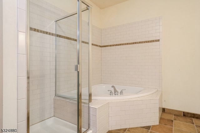 bathroom featuring tile patterned flooring and independent shower and bath