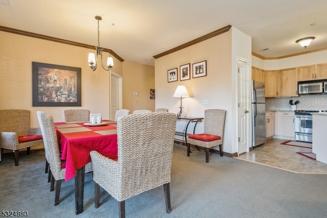 carpeted dining area featuring crown molding and a chandelier