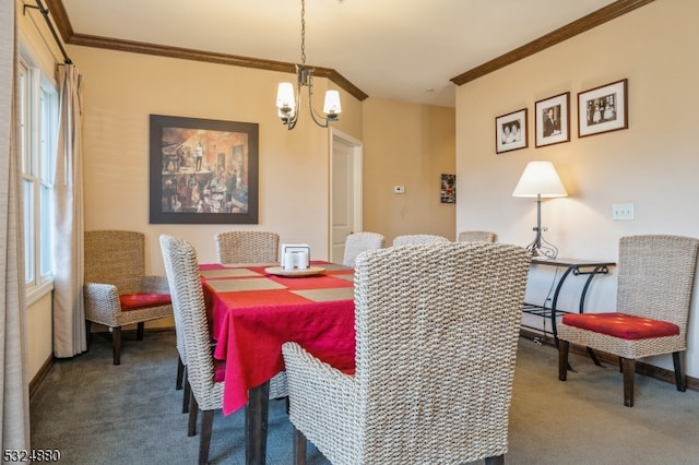 dining room with carpet, a notable chandelier, and ornamental molding