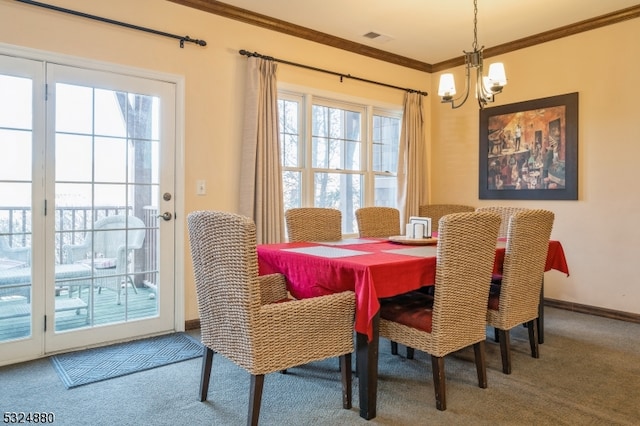 dining space with carpet, an inviting chandelier, plenty of natural light, and crown molding