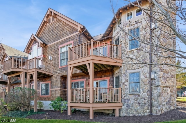 back of property featuring a balcony