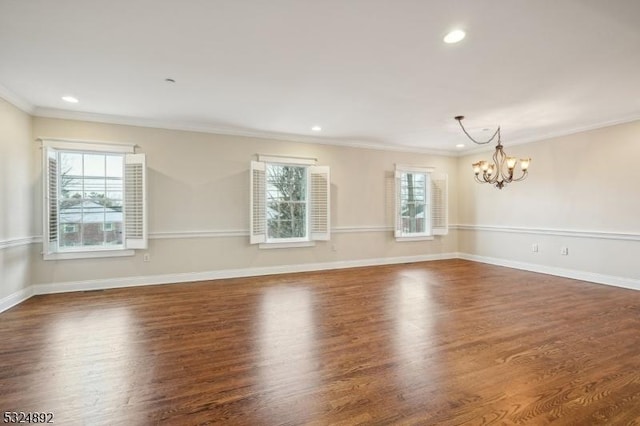 unfurnished room with baseboards, wood finished floors, crown molding, a chandelier, and recessed lighting