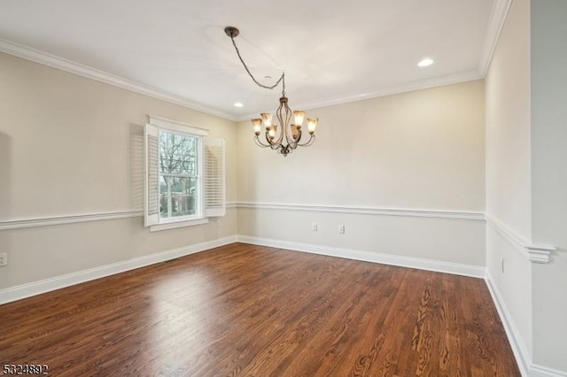 spare room with crown molding, recessed lighting, an inviting chandelier, wood finished floors, and baseboards