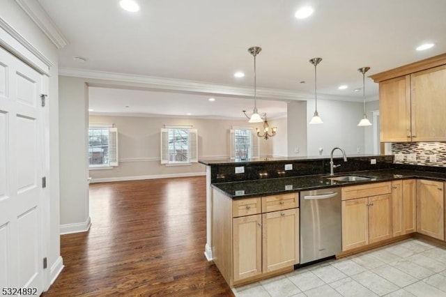 kitchen with open floor plan, a peninsula, a sink, crown molding, and stainless steel dishwasher