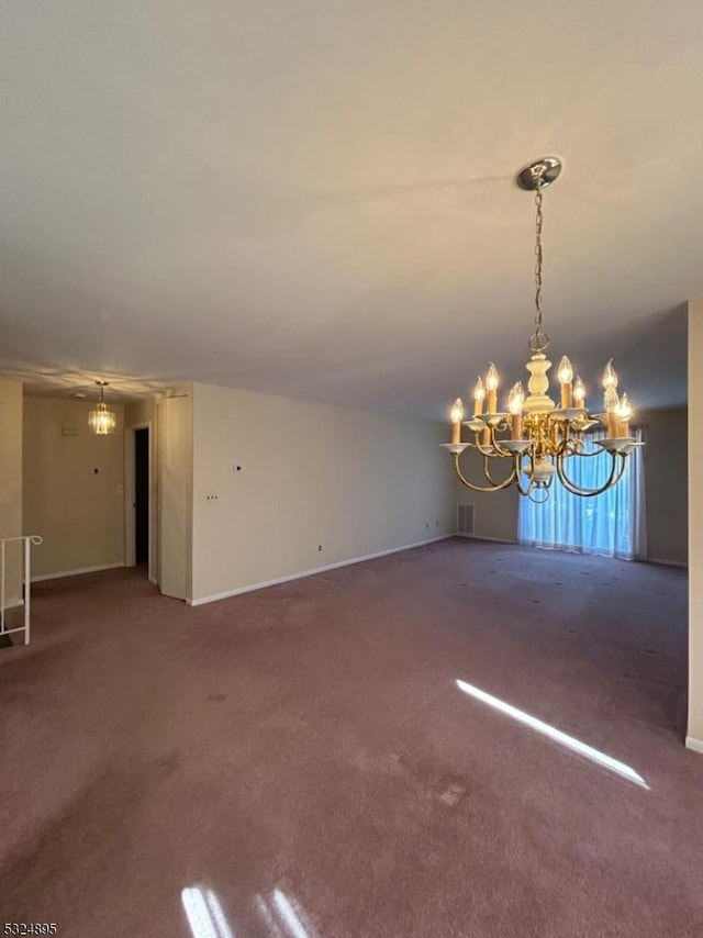 unfurnished room with carpet and a notable chandelier