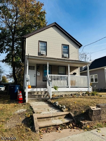 view of front of house with a porch and cooling unit