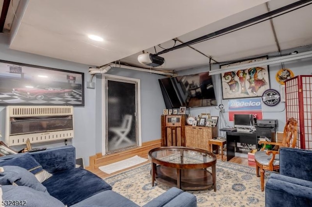 living room with heating unit and hardwood / wood-style floors