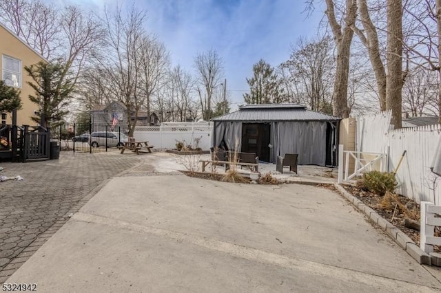 exterior space featuring a gazebo and an outbuilding