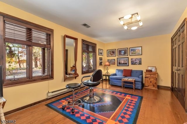 living area featuring hardwood / wood-style flooring and a baseboard radiator