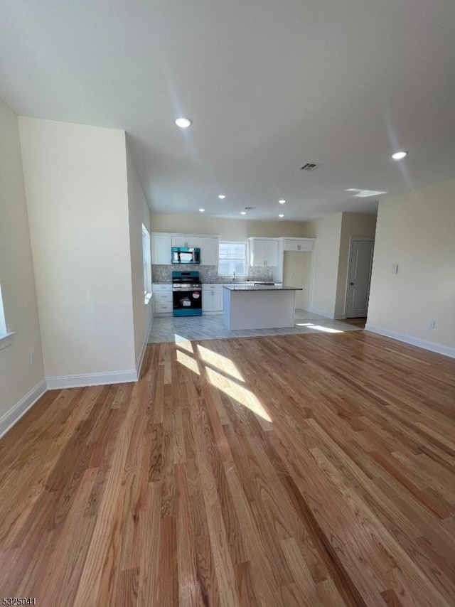 unfurnished living room featuring light hardwood / wood-style floors