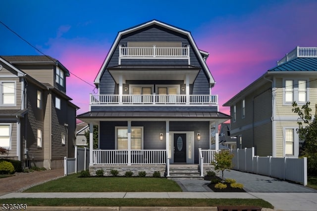 view of front of house with covered porch and a balcony