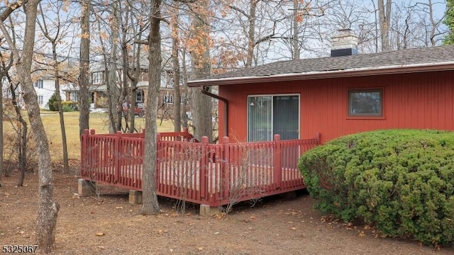 view of side of property featuring a wooden deck