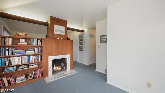 sitting room featuring dark colored carpet