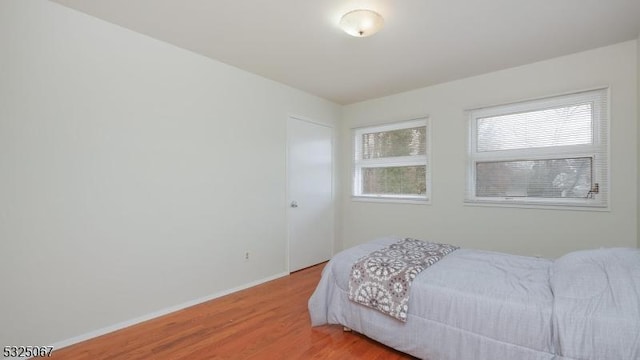 bedroom with hardwood / wood-style floors