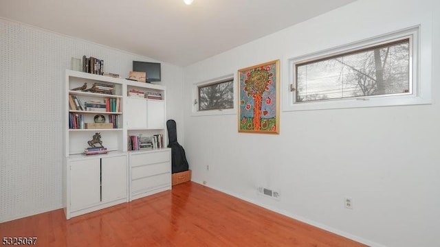 interior space featuring lofted ceiling and light hardwood / wood-style flooring