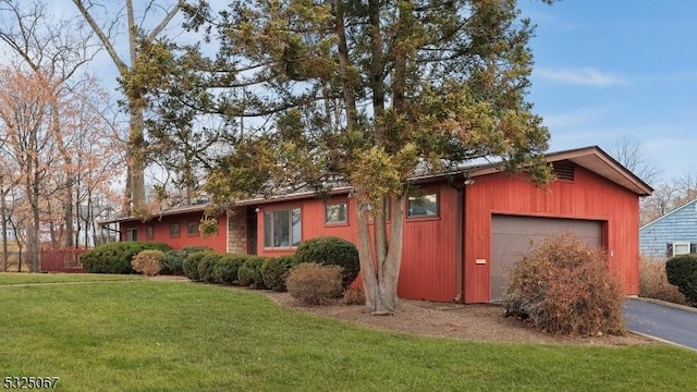 view of front of property with a garage and a front yard