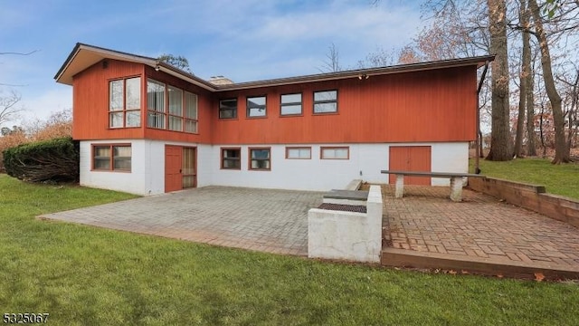 back of property featuring a yard and a patio