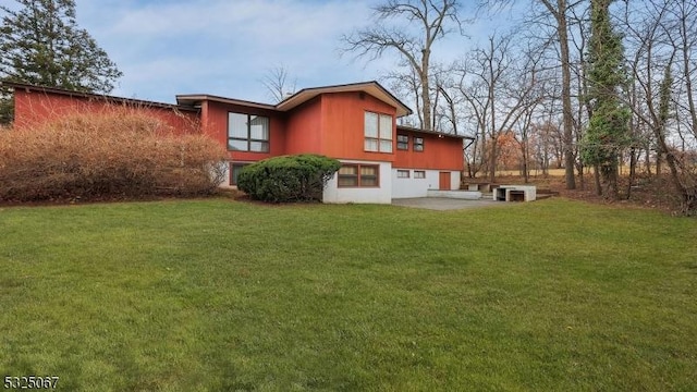 back of property featuring a yard, a patio, and cooling unit