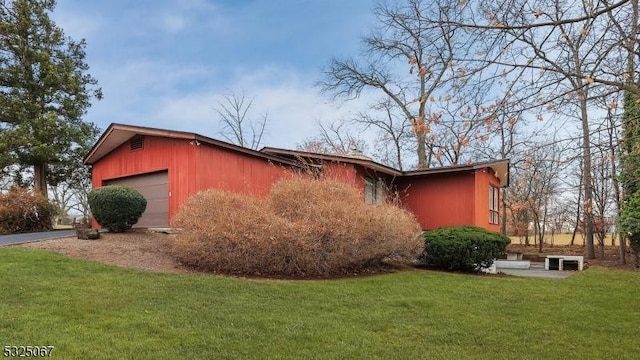 view of side of property with a yard and an outdoor structure